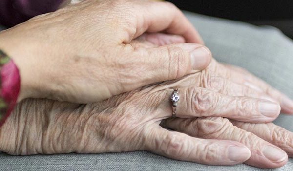 Close up image of people holding hands