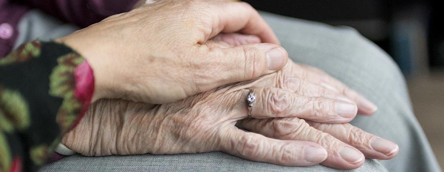 Close up image of people holding hands