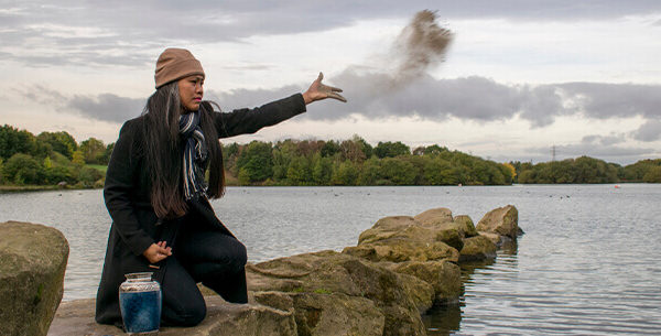 Person spreading ashes into the sea