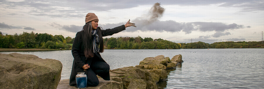 Person spreading ashes into the sea