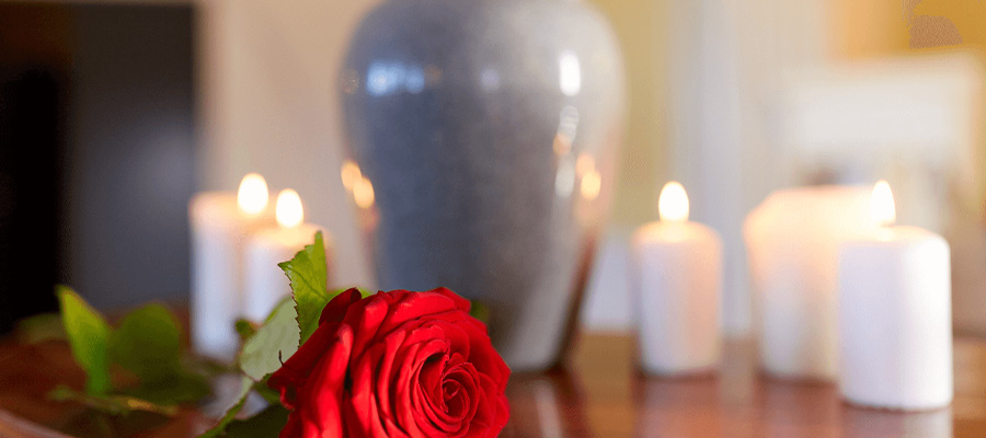 Urn with lit candles and rose