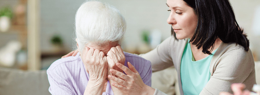 Person in grief receiving comfort