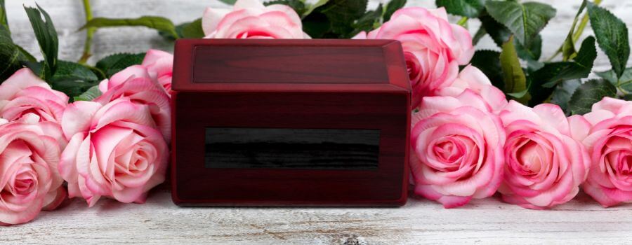 cremation box with pink roses around it
