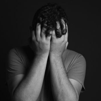 sad man man with face in hands