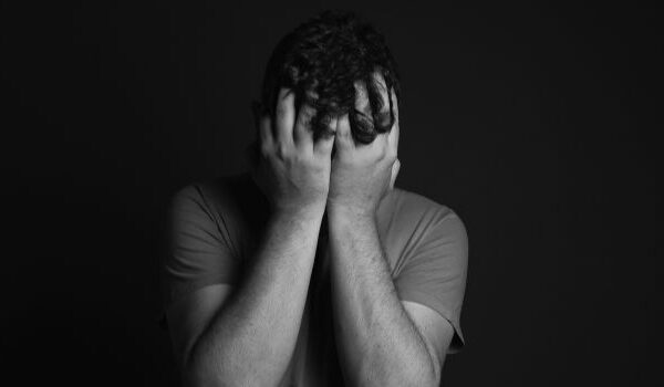 man with face in hands