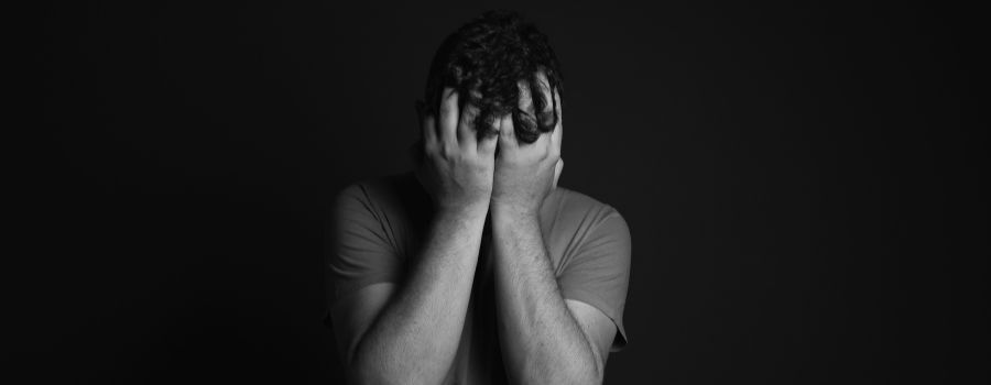 man with face in hands